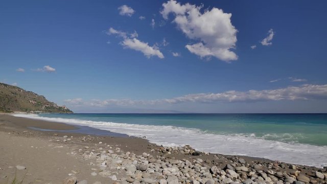 Beautiful waves on sandy beach on Sicili, Italy. Sunny day on the beach.