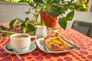 Breakfast of coffee with apple pie on the terrace
