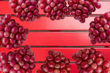 Red grapes on a red table in a circle. Top view.
