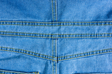 Blue washed faded jeans texture with seams