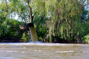 Irrigation water flow from pipe to canal for rice fields and agriculture