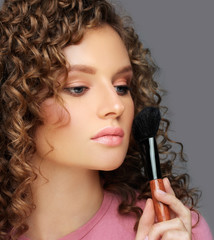 Applying Make-up. Woman with a brush for make-up