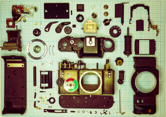 parts old retro film SLR camera on graph paper