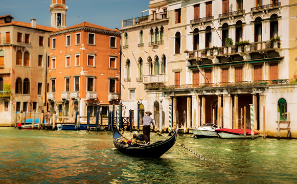 Italy, Venice gondola, gondolier and colourful townhouses