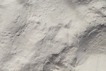 White sand beach texture. Marine coast top view photo. Natural texture. Smooth sand surface with wind marks.