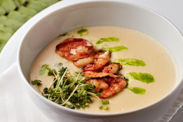Creamy cheese soup with grilled shrimps