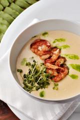 Creamy cheese soup with grilled shrimps