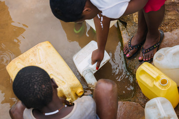 people getting water at a well in Uganda, Africa © Dennis