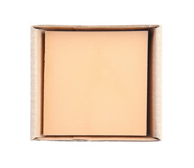 Hand made soap bar in cardboard package on white background, top view