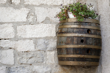 Wine barrel on the wall of the building.