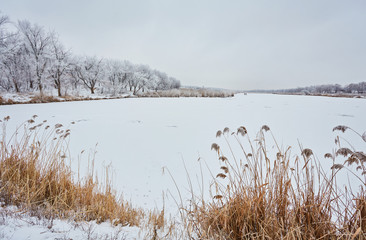 frozen lake on sunny winter's day with blue sky