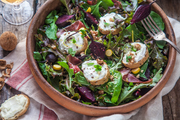 Beet and goat cheese salad in a pot, rustic style