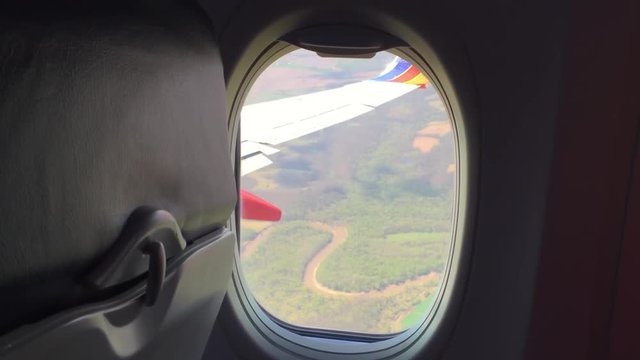POV shot looking out an airliner window whilst the plane turns.