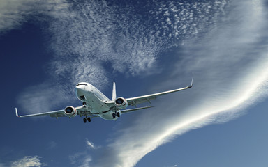 Aircraft in flight with (CLOUD TYPE) cloud in blue sky. Australia.