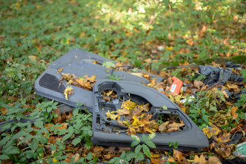 Garbage left in the forest. Littered with various plastic impurities.