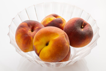 Juicy organic peaches on the kitchen table waiting to be eaten