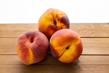 Naklejka na ściany i meble Juicy organic peaches on the kitchen table waiting to be eaten