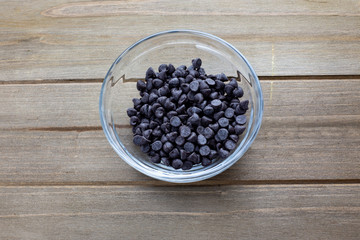 Piles of chocolate chip cookies on the kitchen table waiting to be used in baking chocolate chip cookies in the kitchen