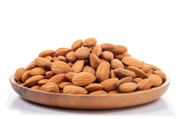 Almonds in wooden dish on white background.