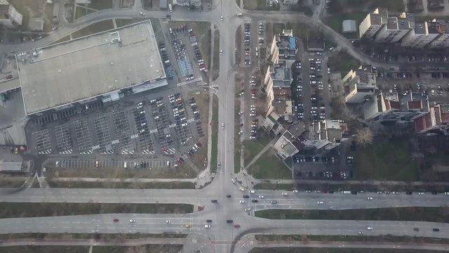 Flying over a concrete living apartment area in east Europa with many birds flying around the drone