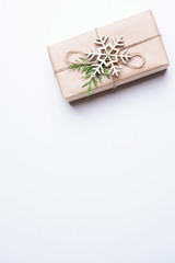 Christmas greeting card with decorated gift box. Minimalistic holiday design with copy space