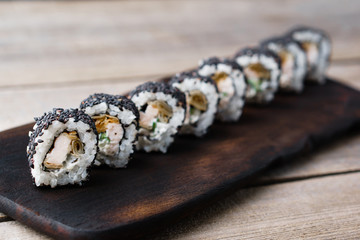Restaurant menu, Japanese food art. Appetizing sushi rolls served on wooden tray