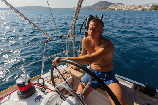 Man skipper runs a sailing yacht on the Sea.