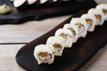 Japanese restaurant menu, professional culinary, delicious and beautiful food. Tasty appetizing sushi rolls with crab meat, close up