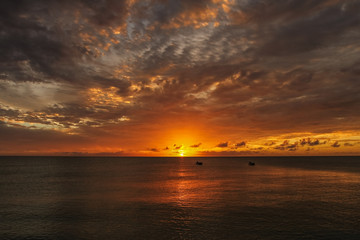 Orange sunset over the ocean at Caribbean islands