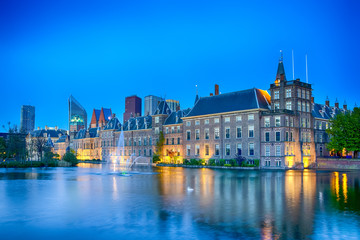 Fototapeta na wymiar Travel Concepts. Binnenhof Palace of Parliament in The Hague in The Netherlands at Blue Hour. Against Modern Skyscrapers on Background.