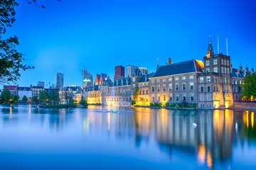 Fototapeta na wymiar Travel Concepts. Binnenhof Palace of Parliament in The Hague in The Netherlands at Blue Hour. Against Modern Skyscrapers on Background.