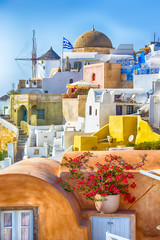 Travel Ideas and Concepts. Amazing Picturesque Santorini Island in Greece. Wonderful Daylight Scenery with Traditional Greek White Architecture. Located in Oia Village and Ochre Domed Church.