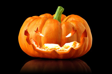 Single orange pumpkin jack-o-lantern isolated on black