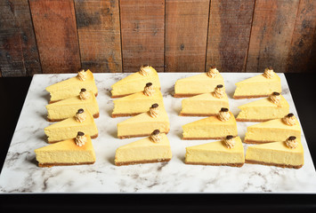 Slice of NY style Cheese cake on buffet table 