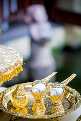 Thai wedding accessory for cultural wedding ceremony, luxury chair for bride and groom, golden tray with pedestal and the others. image for wedding objects, copy space and advertisement.