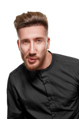 Portrait of a serious bearded man in a black shirt, isolated over a white background.
