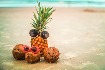 Cute Pineapple and Coconuts Wearing Sunglasses Relaxing By The Ocean