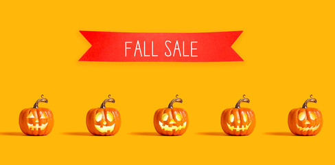 Halloween sale with orange pumpkin lanterns with a red banner