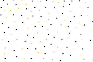 Golden and black spiders confetti on the white background. Halloween children or adult party concept. Holiday vibes. Flat-lay, top view.