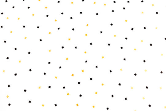 Golden And Black Spiders Confetti On The White Background. Halloween Children Or Adult Party Concept. Holiday Vibes. Flat-lay, Top View.