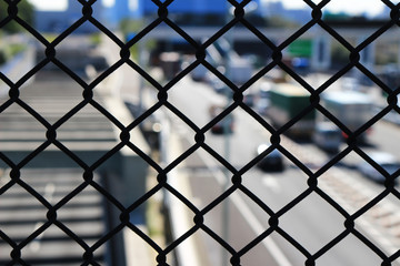 Naklejka premium Wire mesh surrounding highway
