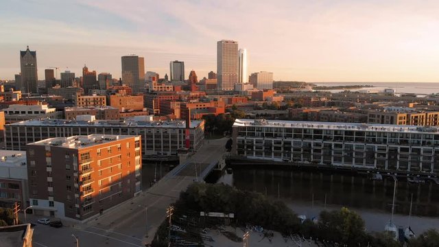 Milwaukee river in downtown, harbor districts of Milwaukee, Wisconsin, United States. Real estate, condos in downtown. Aerial view, drone flying 
