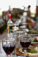 glass of red wine and bottle of white wine 