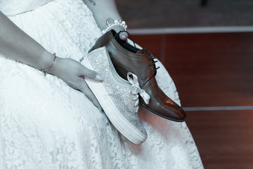 bride holding his and her shoes