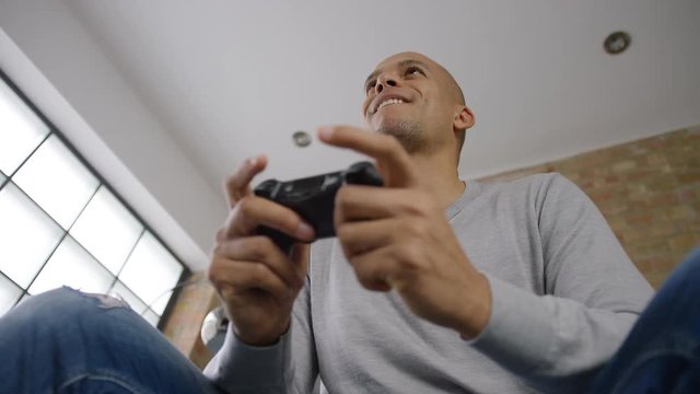 Abstract angle of man playing video games at home