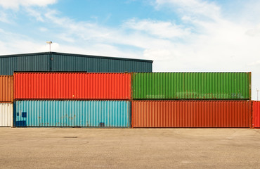 Shipping containers stacked outdoors.