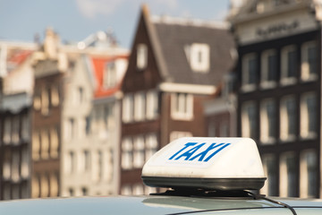 A taxi sign with blue letter on a taxi car in Amsterdam.