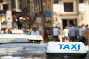 A taxi sign with blue letter on a taxi car in Amsterdam.