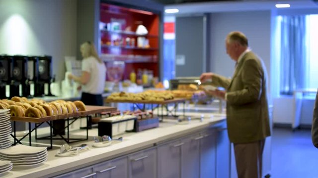 Corporate cafeteria with bagels and other breakfast items
