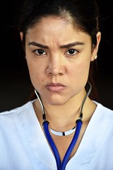 Unhappy Young Colombian Nurse Wearing Scrubs